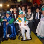 Men in wheelchairs surrounded by people in formal wear
